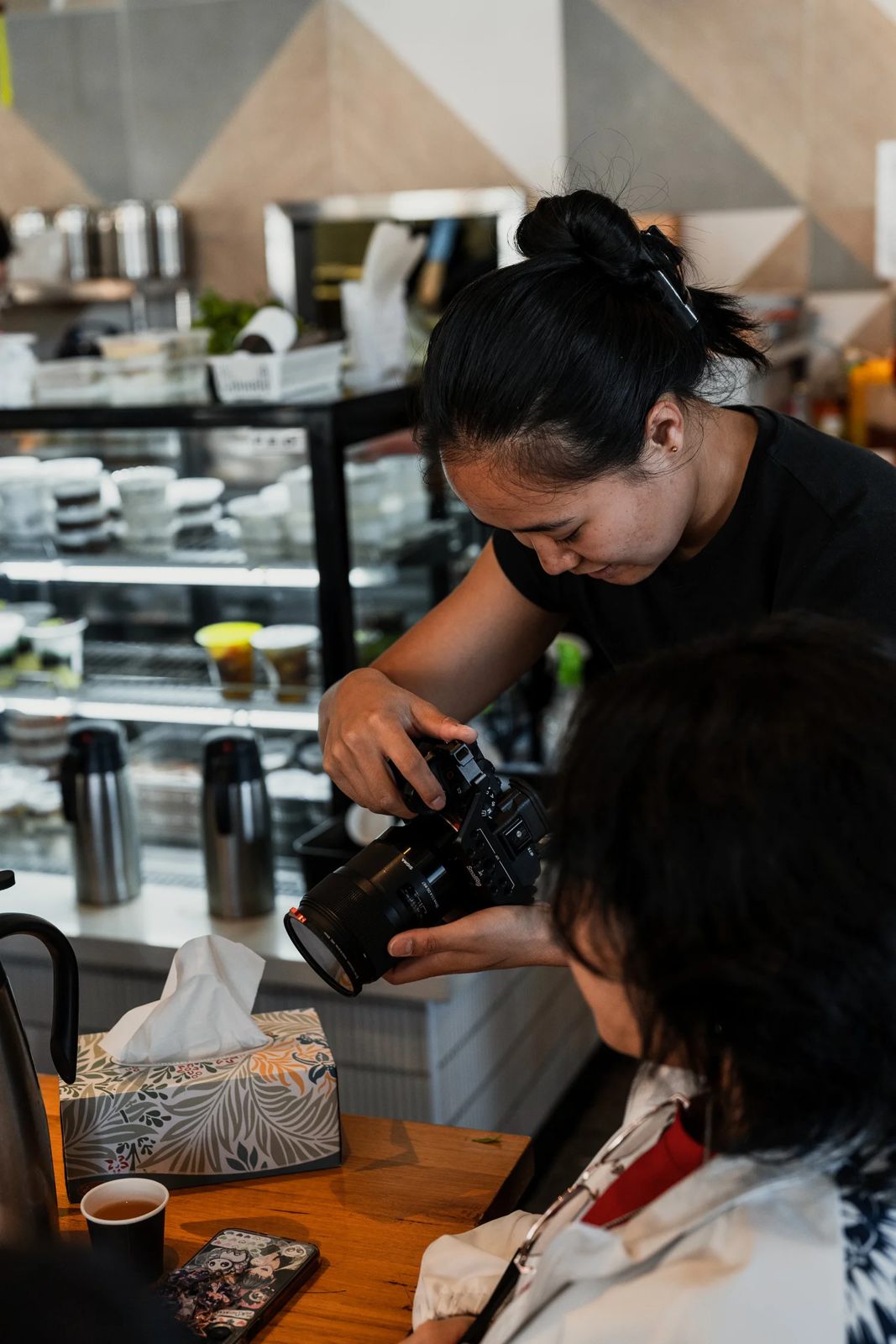 Terresa from TASU Media filming in a cafe