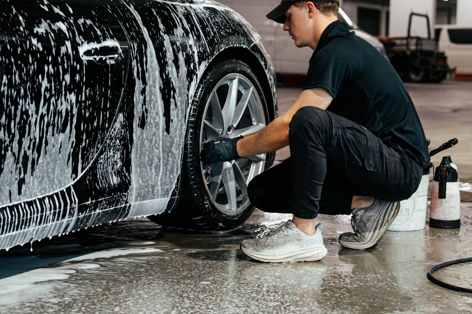 Detailer hand washing a car wheel