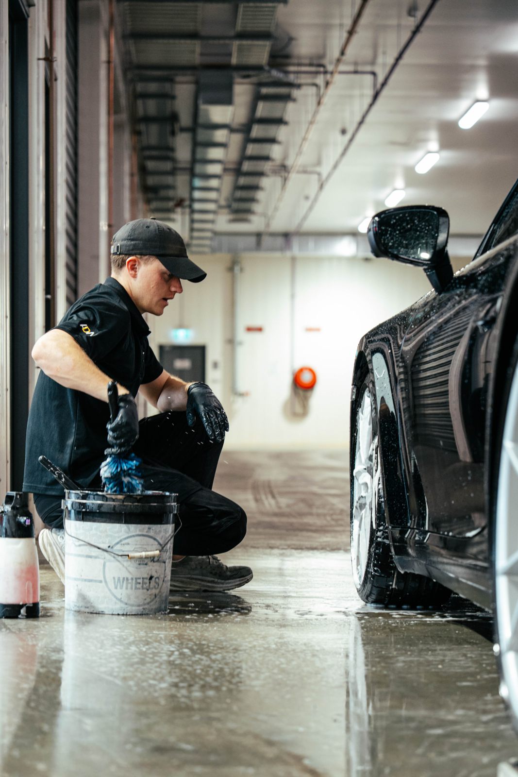 Detailer washing a car by hand