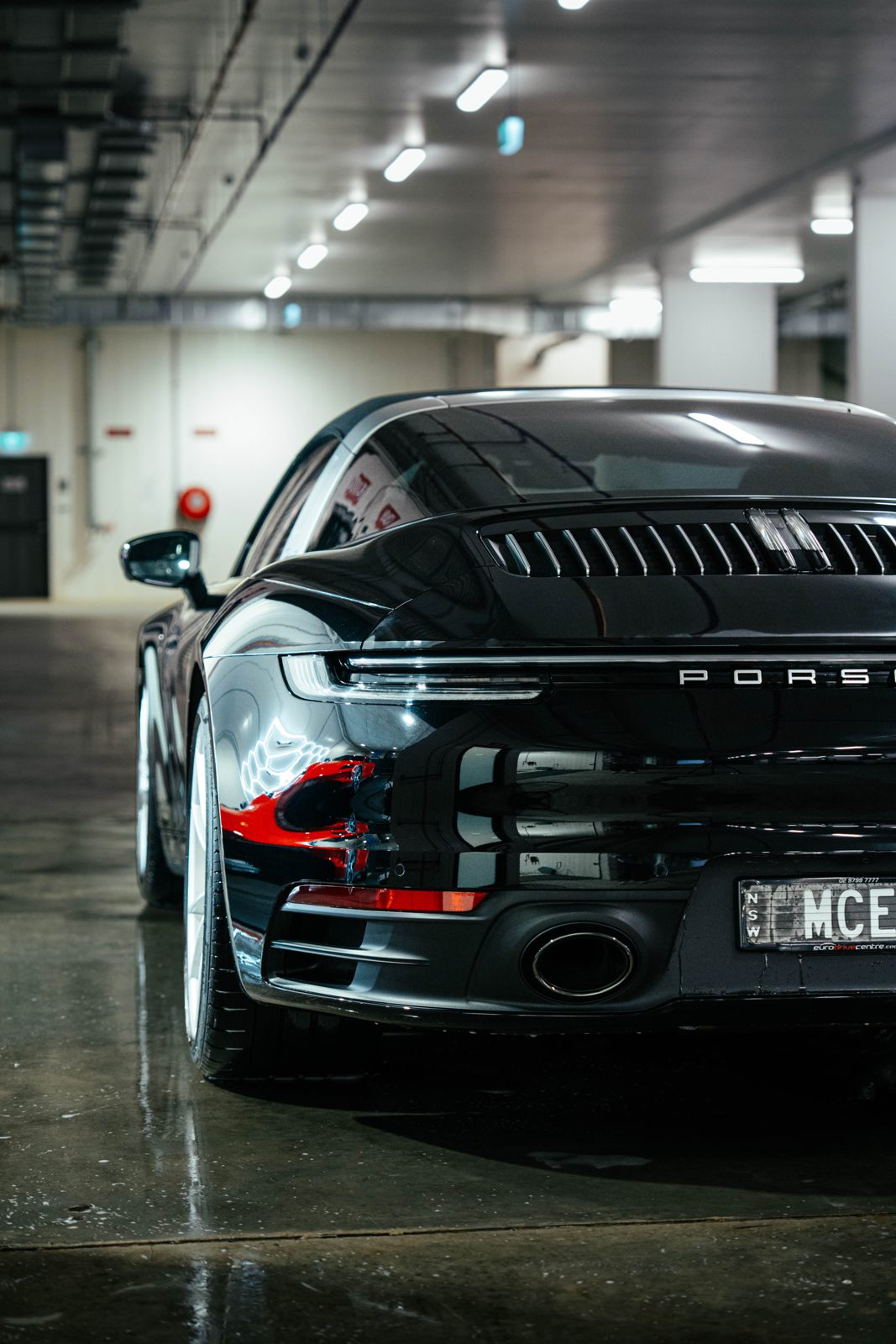 Black Porsche 911 in a detailing studio