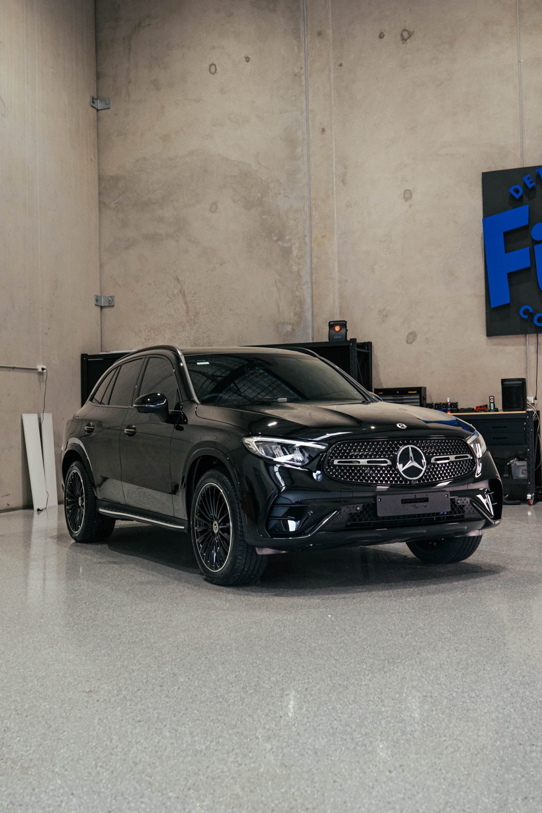Black Mercedes SUV in a detailing studio